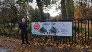 Niven Rennie standing with Moira's Run promotional banner