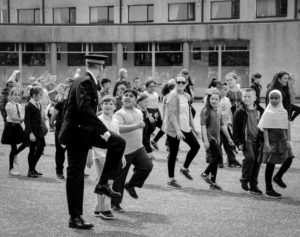 Policeman teaching kids how to march at the Police Scotland College