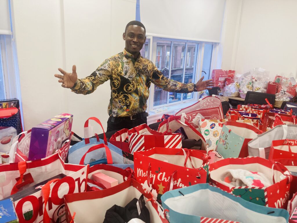 Emmanuel from OCS with the donated Christmas presents