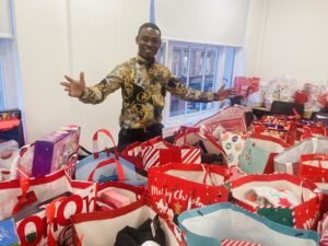 Emmanuel from OCS with the donated Christmas presents