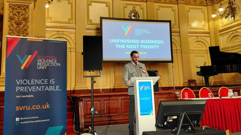 Jimmy Paul on-stage delivering the opening of the Unfinished Business conference